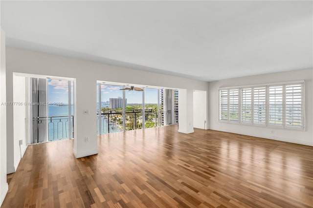 11111 Biscayne Blvd Unit 16G, Miami, FL 33181 - unfurnished living room featuring baseboards, ceiling fan, and wood finished floors