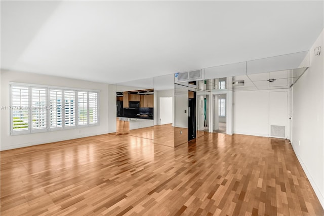 11111 Biscayne Blvd Unit 16G, Miami, FL 33181 - unfurnished living room with visible vents, light wood finished floors, and baseboards