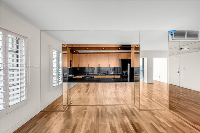11111 Biscayne Blvd Unit 16G, Miami, FL 33181 - interior space featuring decorative backsplash, visible vents, dark countertops, light wood-type flooring, and a sink