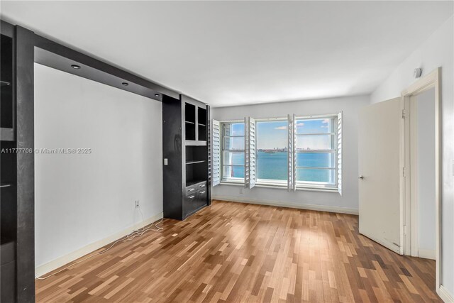 11111 Biscayne Blvd Unit 16G, Miami, FL 33181 - spare room featuring baseboards and light wood finished floors