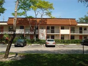 870 NE 207th Ter Unit 201-9, Miami, FL 33179 - view of property featuring uncovered parking