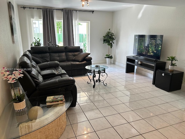 1138 NW 124th Ave Unit 2301, Miami, FL 33182 - living area featuring baseboards, light tile patterned flooring, and a textured wall