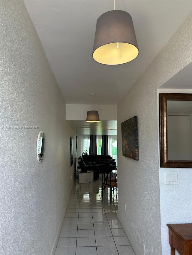 1138 NW 124th Ave Unit 2301, Miami, FL 33182 - hall with a textured wall, baseboards, and light tile patterned flooring