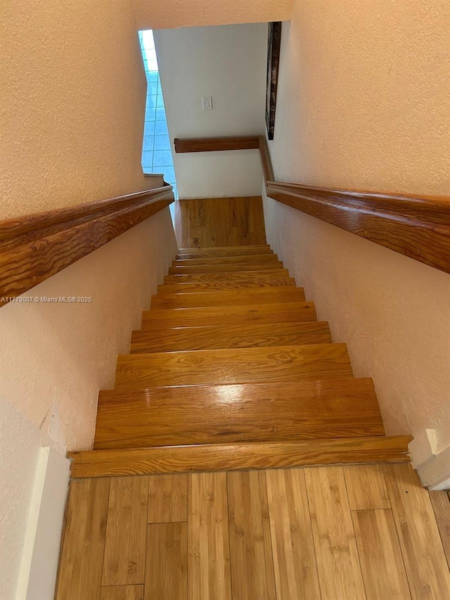 1138 NW 124th Ave Unit 2301, Miami, FL 33182 - stairs featuring a textured wall and wood finished floors