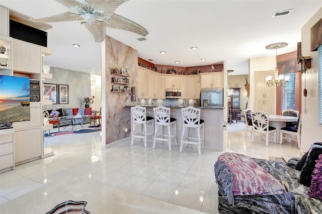 living area featuring ceiling fan with notable chandelier, light tile patterned floors, visible vents, and recessed lighting