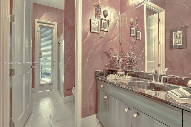 bathroom with vanity, marble finish floor, and toilet