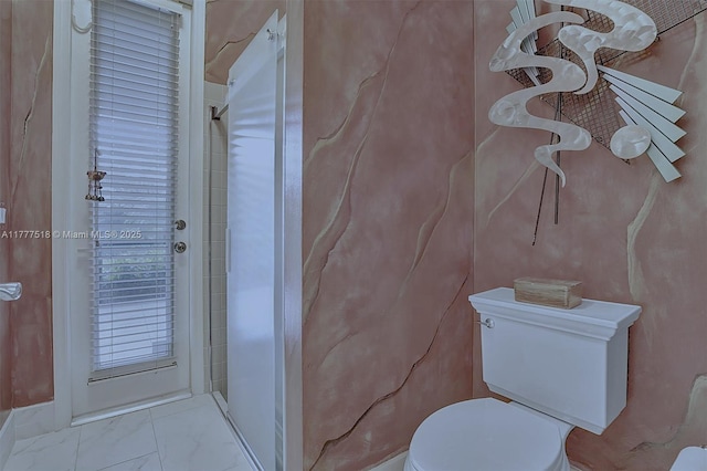bathroom with marble finish floor, walk in shower, and toilet