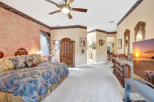 carpeted bedroom featuring crown molding, visible vents, baseboards, and ceiling fan