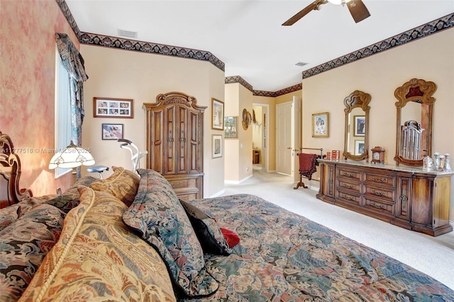 carpeted bedroom featuring baseboards, a ceiling fan, and visible vents