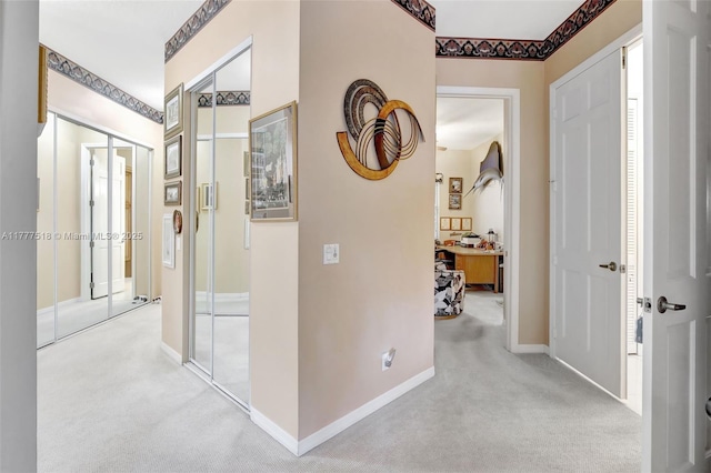 hall with baseboards and carpet floors