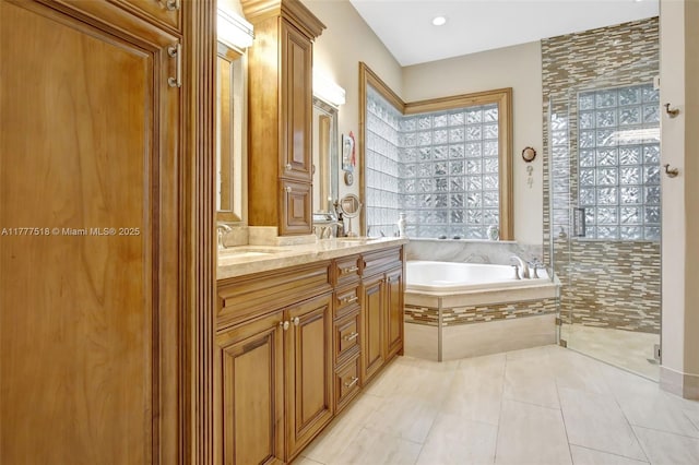 full bath with a bath, a sink, a tile shower, double vanity, and tile patterned floors