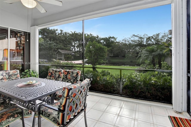 sunroom / solarium featuring ceiling fan