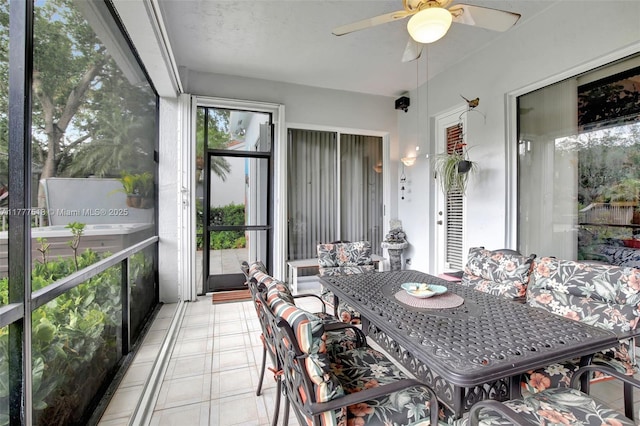 sunroom featuring a ceiling fan