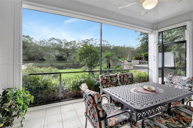 sunroom with outdoor dining space and a ceiling fan