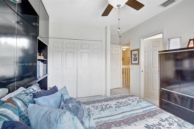 bedroom with carpet flooring, a ceiling fan, and visible vents