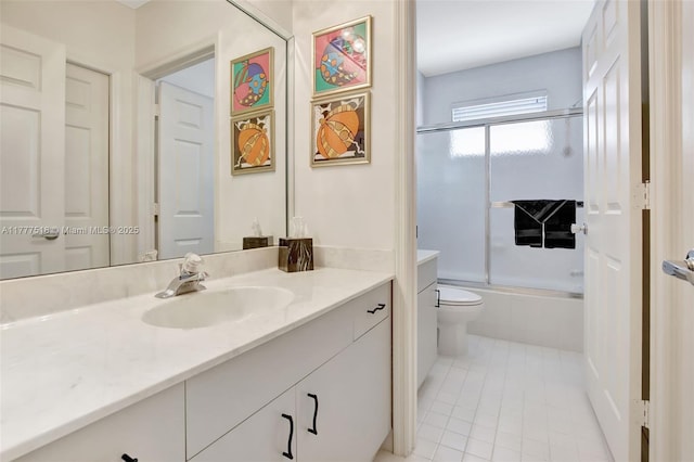 full bathroom with tile patterned floors, vanity, toilet, and bath / shower combo with glass door