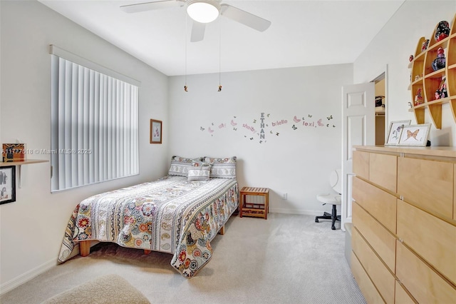 bedroom with ceiling fan, carpet flooring, and baseboards