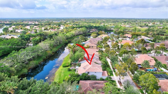 birds eye view of property with a water view and a residential view