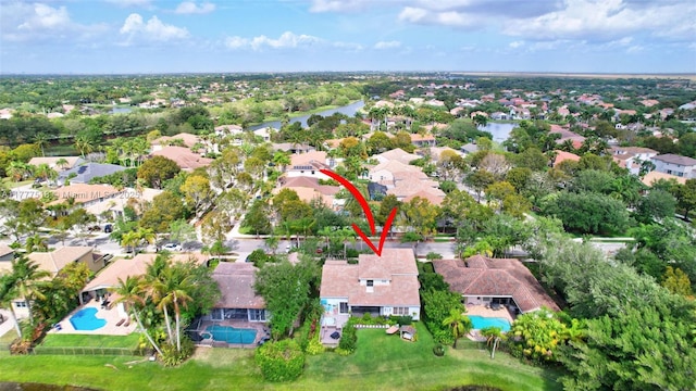 drone / aerial view featuring a water view and a residential view