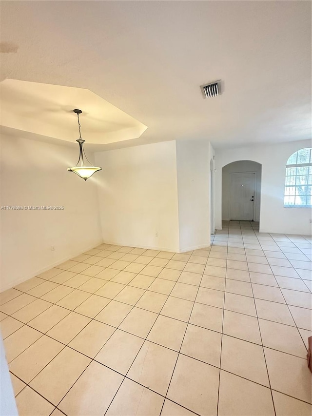 5031 SW 135th Ave Unit 5031, Miramar, FL 33027 - spare room with arched walkways, light tile patterned flooring, and a raised ceiling