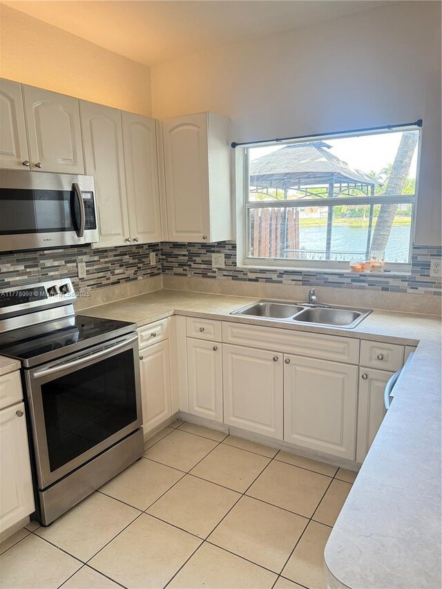 5031 SW 135th Ave Unit 5031, Miramar, FL 33027 - kitchen with stainless steel appliances, light countertops, decorative backsplash, and light tile patterned floors