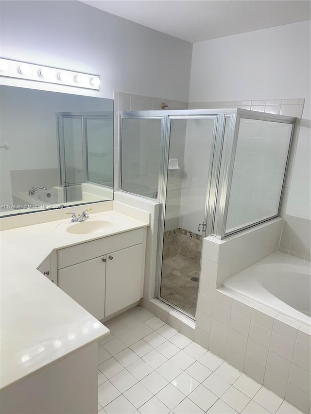 5031 SW 135th Ave Unit 5031, Miramar, FL 33027 - full bathroom featuring tile patterned flooring, a shower stall, a bath, and vanity