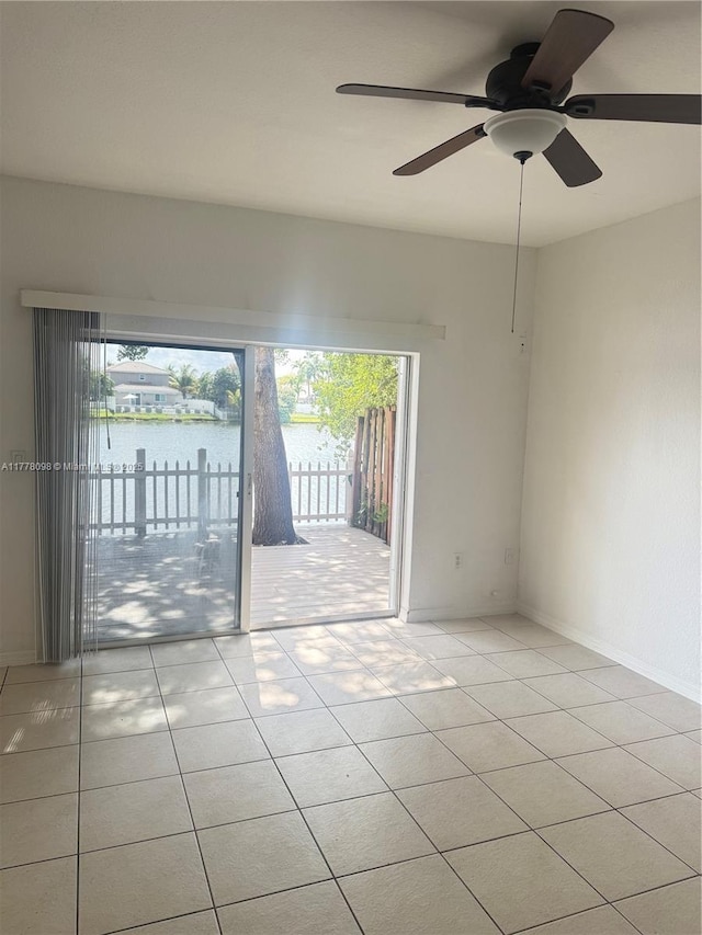 5031 SW 135th Ave Unit 5031, Miramar, FL 33027 - spare room featuring tile patterned floors, a water view, baseboards, and a ceiling fan