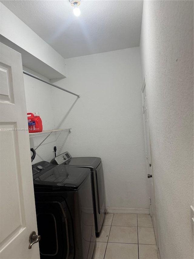 5031 SW 135th Ave Unit 5031, Miramar, FL 33027 - laundry room featuring washing machine and dryer, light tile patterned flooring, and baseboards