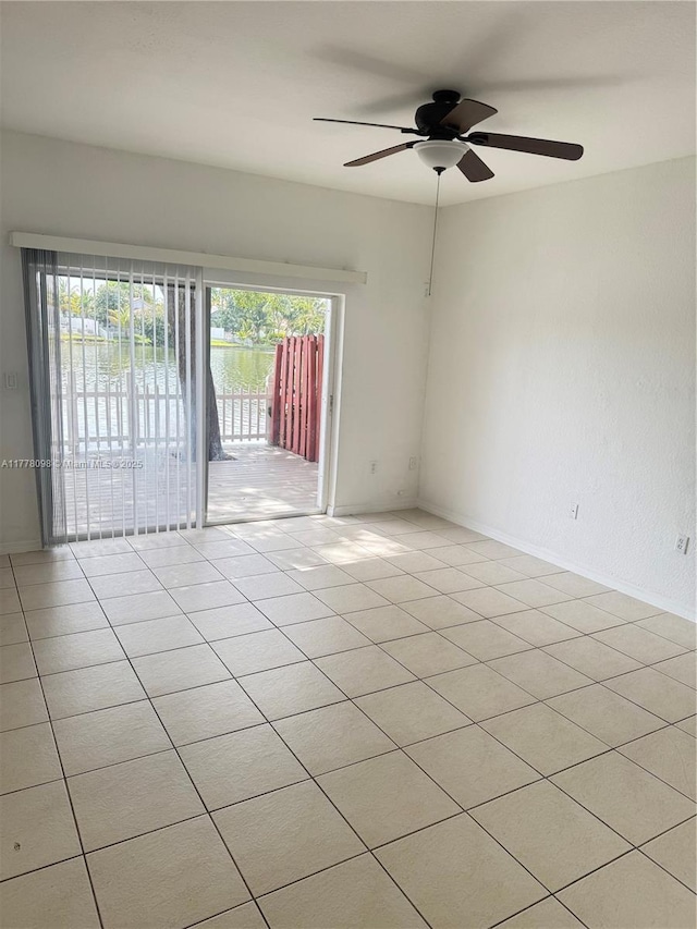 5031 SW 135th Ave Unit 5031, Miramar, FL 33027 - spare room featuring a ceiling fan, light tile patterned floors, and baseboards