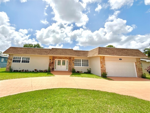 single story home with curved driveway, stucco siding, roof with shingles, a front yard, and a garage