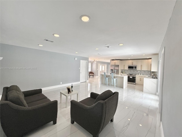 living room featuring marble finish floor, baseboards, visible vents, and recessed lighting