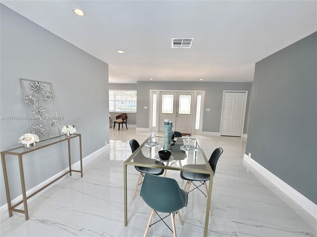 dining space featuring marble finish floor, baseboards, and visible vents