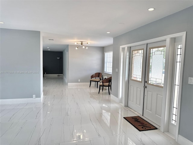 foyer entrance featuring marble finish floor, baseboards, french doors, and recessed lighting