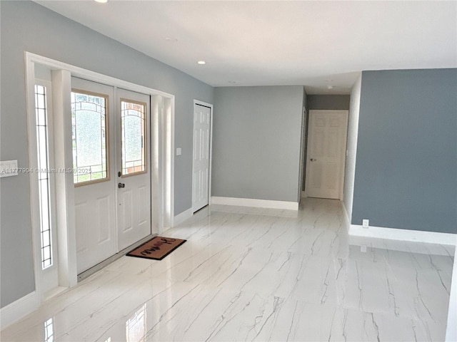 entryway featuring marble finish floor, baseboards, recessed lighting, and french doors