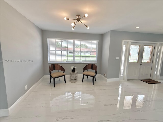 entryway featuring marble finish floor, baseboards, recessed lighting, and an inviting chandelier