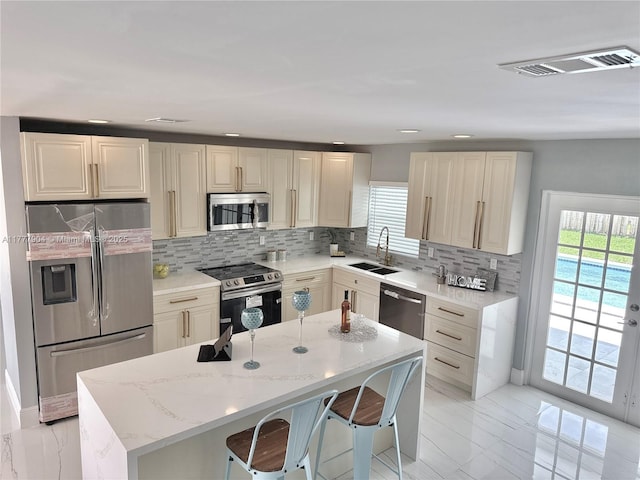 kitchen featuring a sink, plenty of natural light, appliances with stainless steel finishes, and visible vents