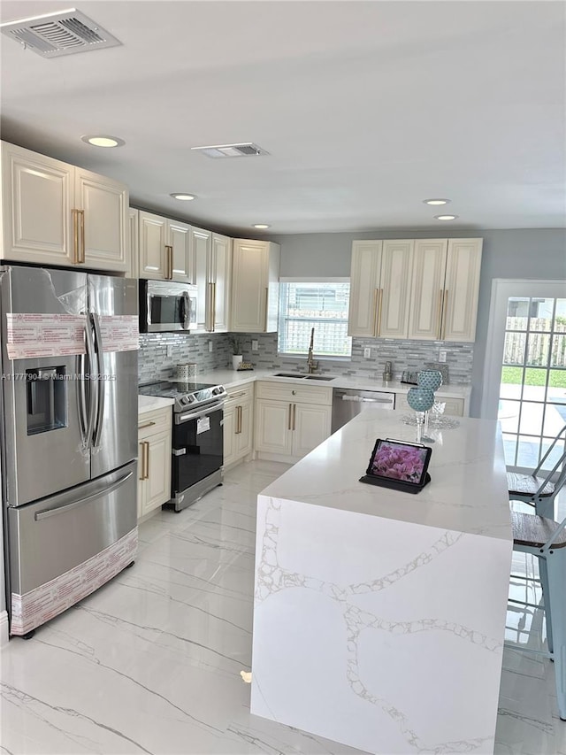 kitchen with marble finish floor, a sink, visible vents, and appliances with stainless steel finishes