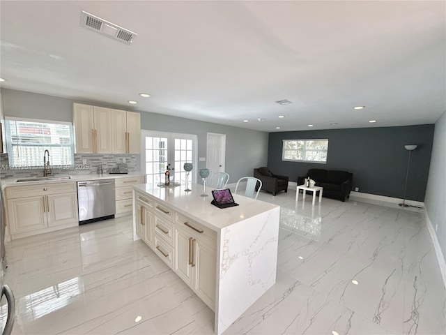 kitchen with visible vents, a sink, a healthy amount of sunlight, and stainless steel dishwasher