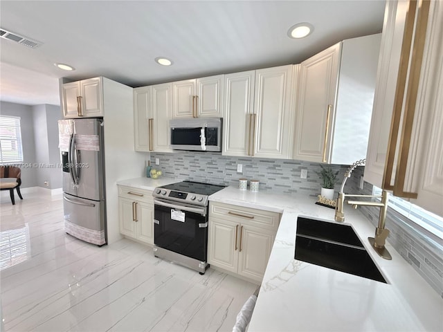 kitchen with recessed lighting, stainless steel appliances, backsplash, a sink, and visible vents