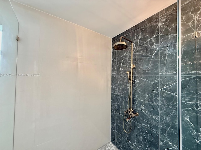 bathroom with tiled shower