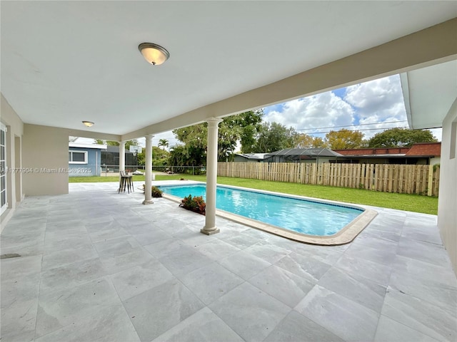 view of swimming pool featuring a fenced backyard, a fenced in pool, a lawn, and a patio