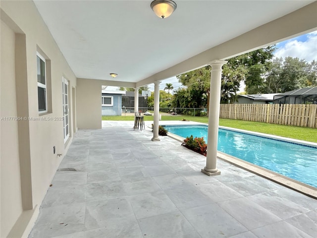view of swimming pool with a lawn, fence, a fenced in pool, and a patio area