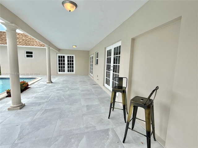 view of patio / terrace with french doors and an outdoor pool