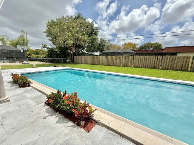 view of swimming pool with a fenced backyard, a yard, a patio area, and a fenced in pool