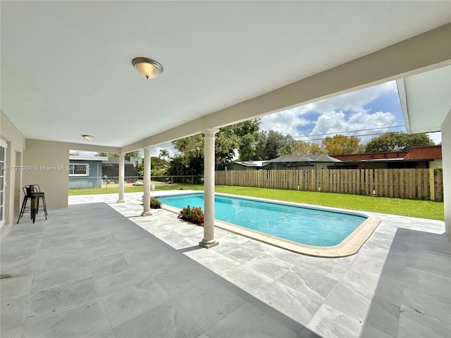 view of swimming pool with a lawn, a fenced in pool, a fenced backyard, and a patio area