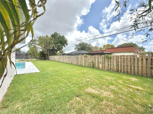 view of yard featuring a fenced in pool and a fenced backyard