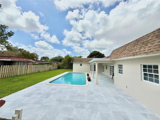 view of swimming pool with a patio, a fenced in pool, a fenced backyard, and a yard