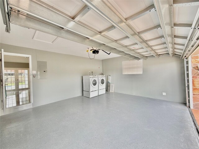 garage with separate washer and dryer and electric panel