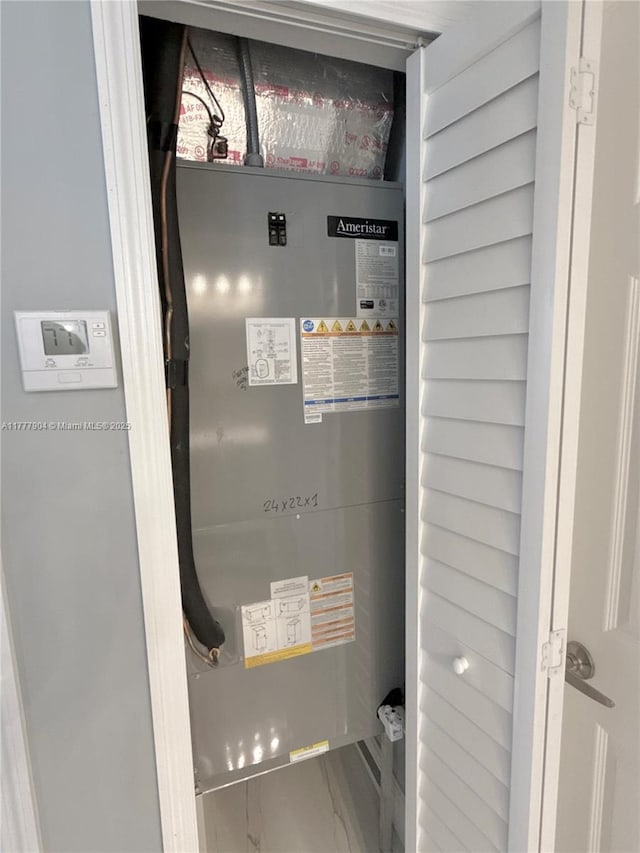 utility room featuring heating unit