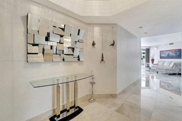 4000 Island Blvd Unit 402, Aventura, FL 33160 - hallway featuring visible vents, baseboards, and a raised ceiling